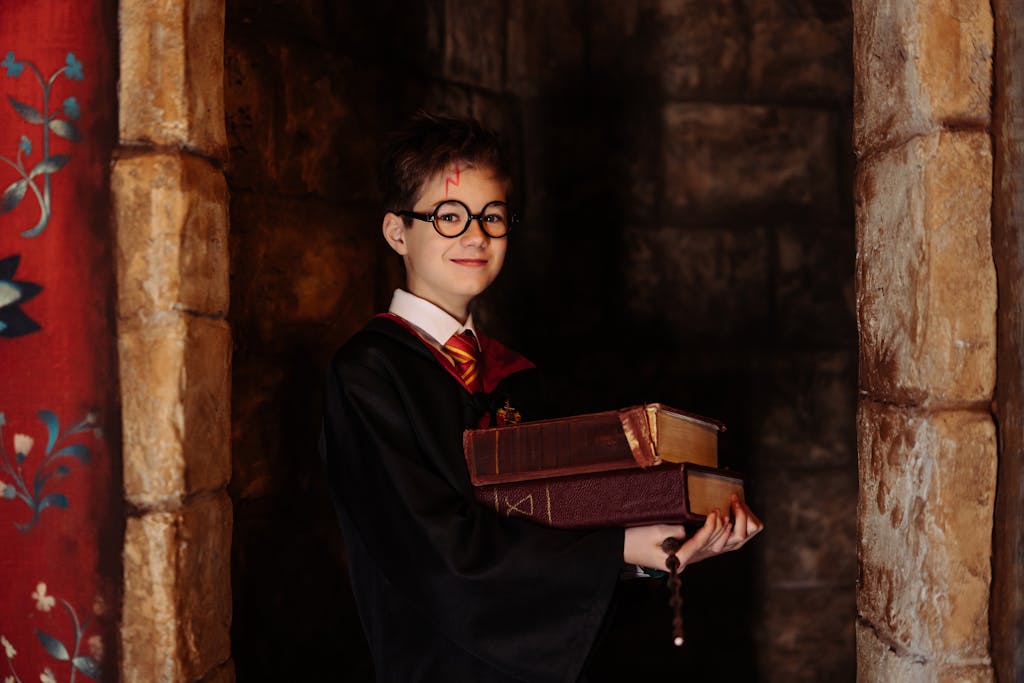Boy in Harry Potter Costume Holding Spellbooks